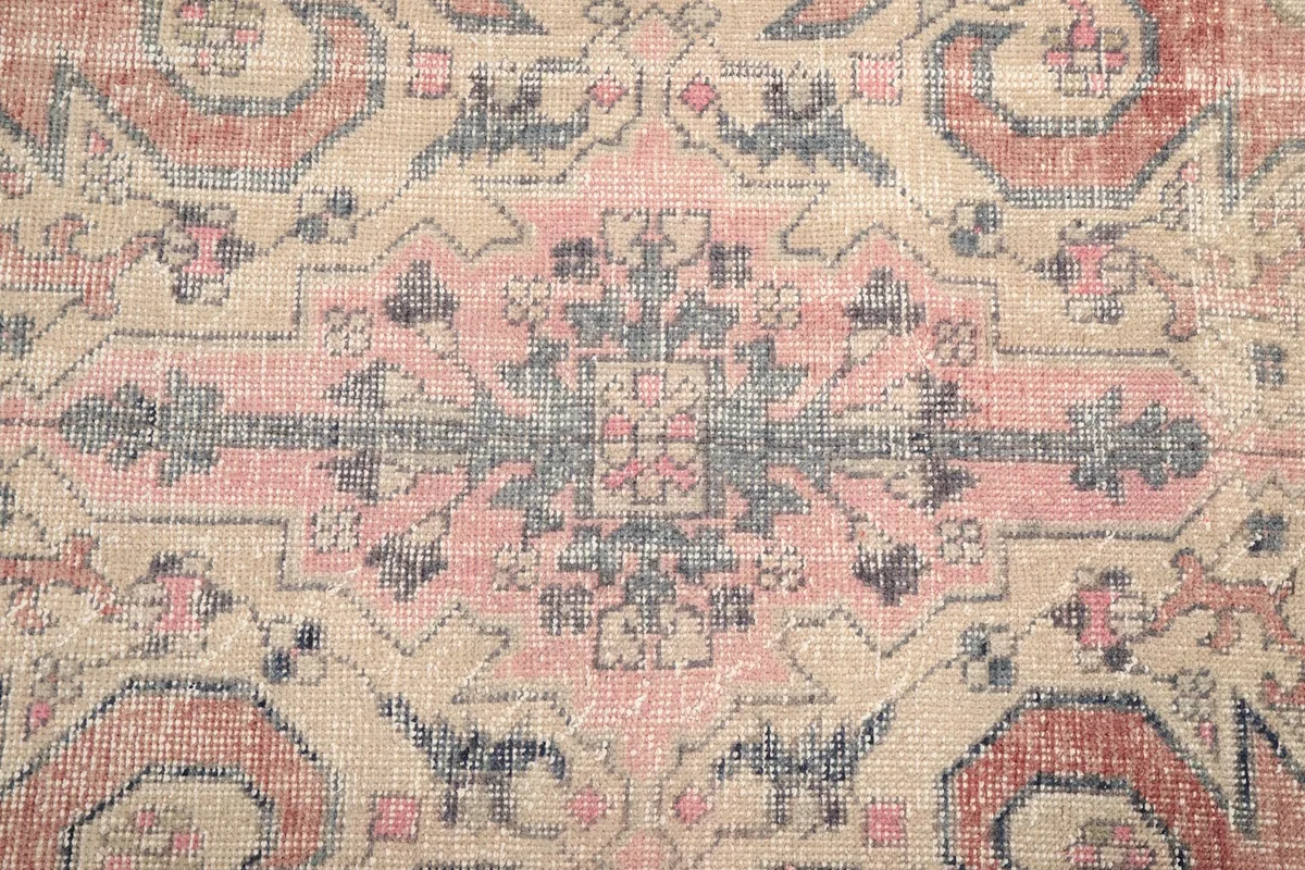Close-up of the central medallion design, showing the intricate patterns and aged texture