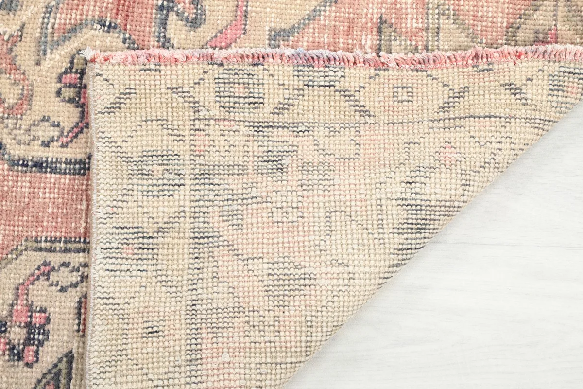 Underside of the rug showing the tight hand-knotting and fringe details
