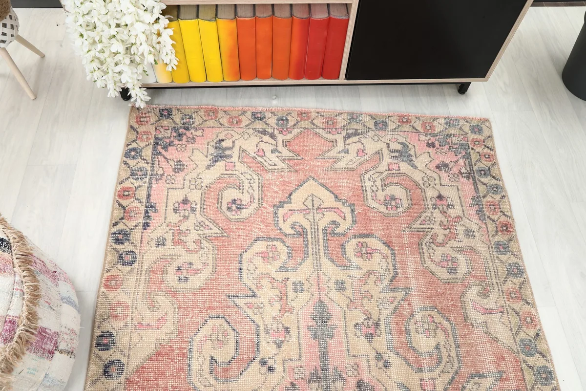 Overhead view of the rug's top half, showing the main field and border designs
