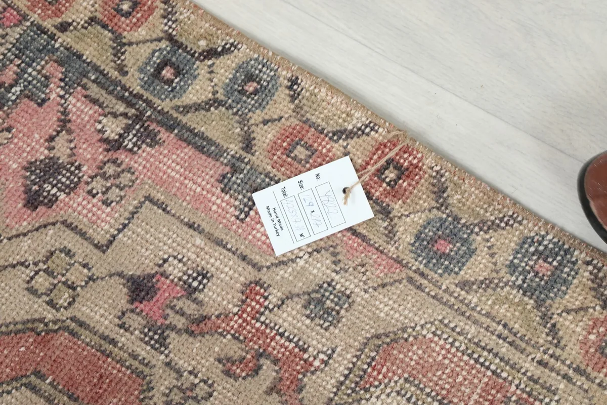 Close-up of the rug's edge and a tag, displaying the texture and weave