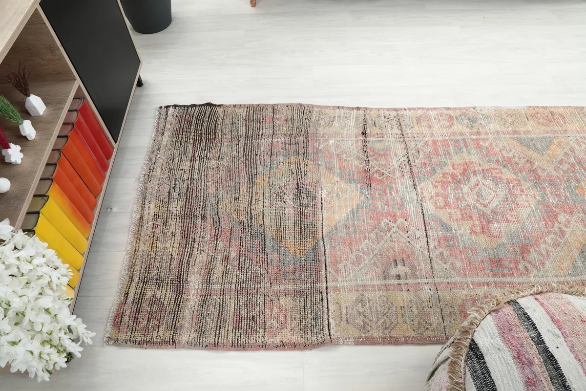 Angle view of the rug's end, illustrating the transition from pile to flat-woven area
