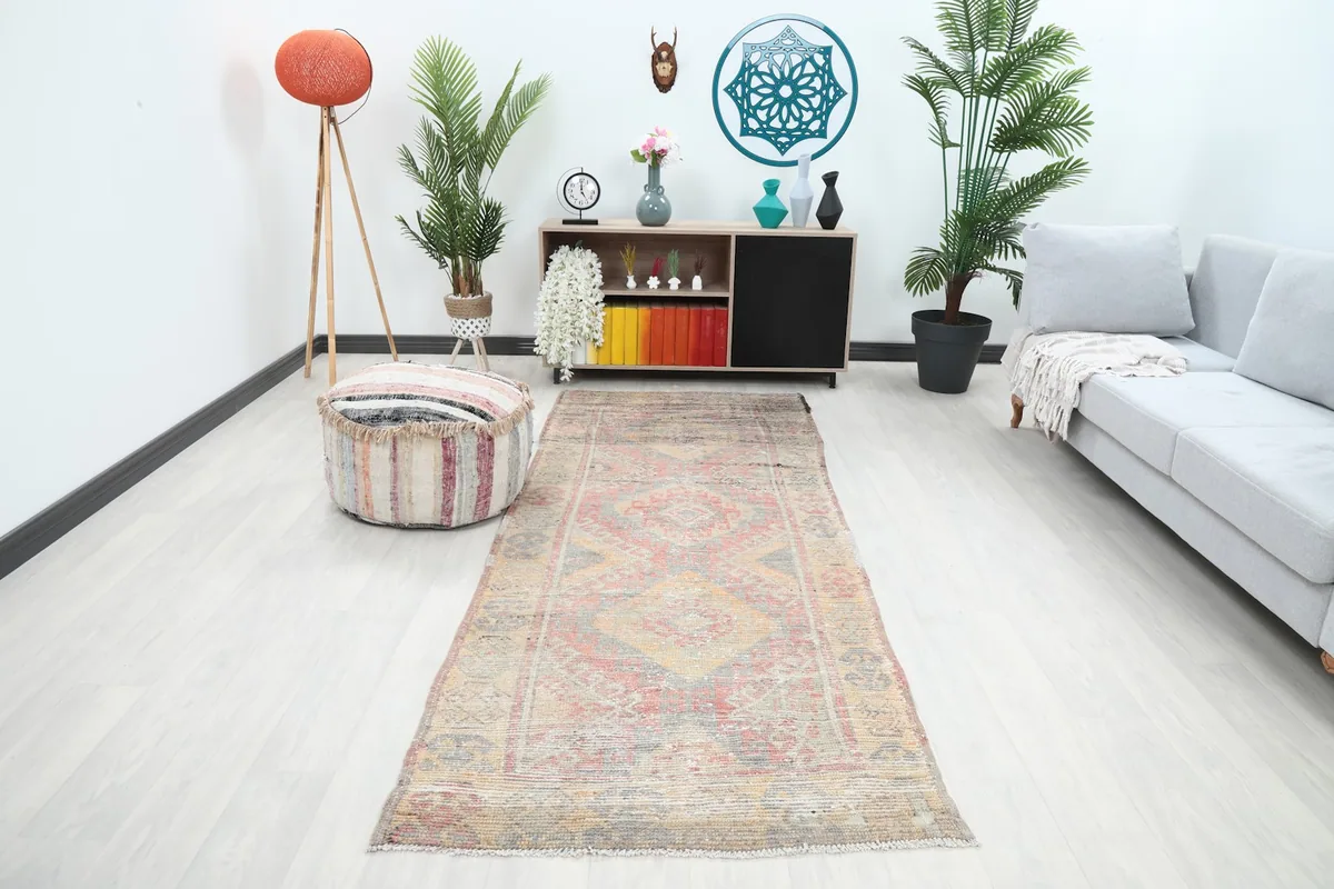 Runner rug displayed in a modern living room setting with light flooring and plants