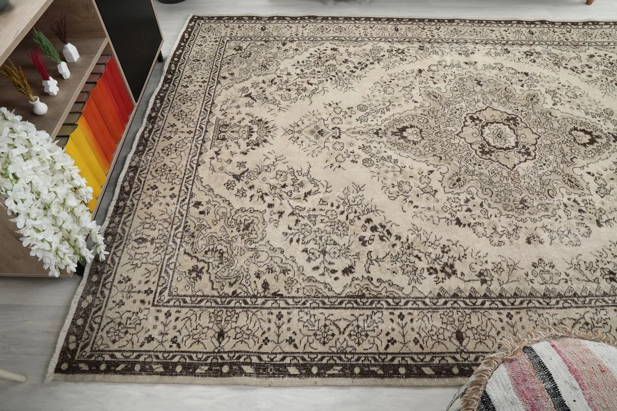 Corner view of the rug in a room, emphasizing its large size and pattern