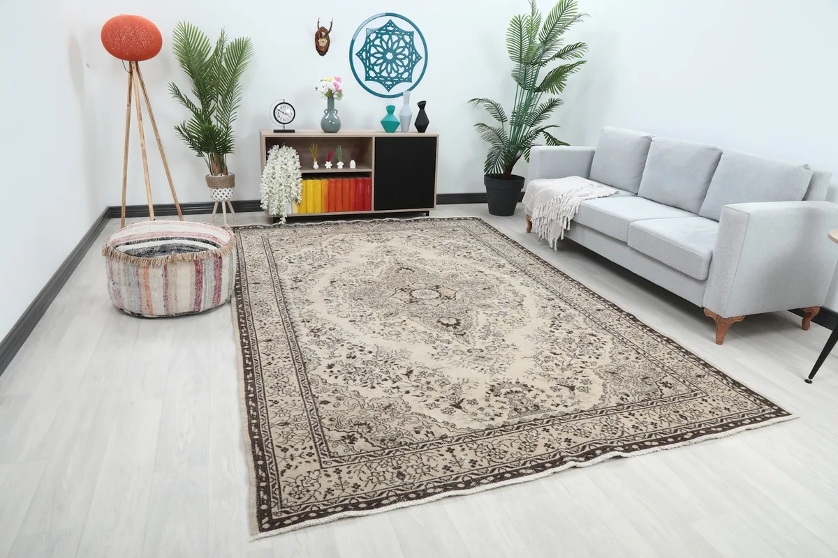 Angle view of the ivory and charcoal vintage rug in a living room with light furniture