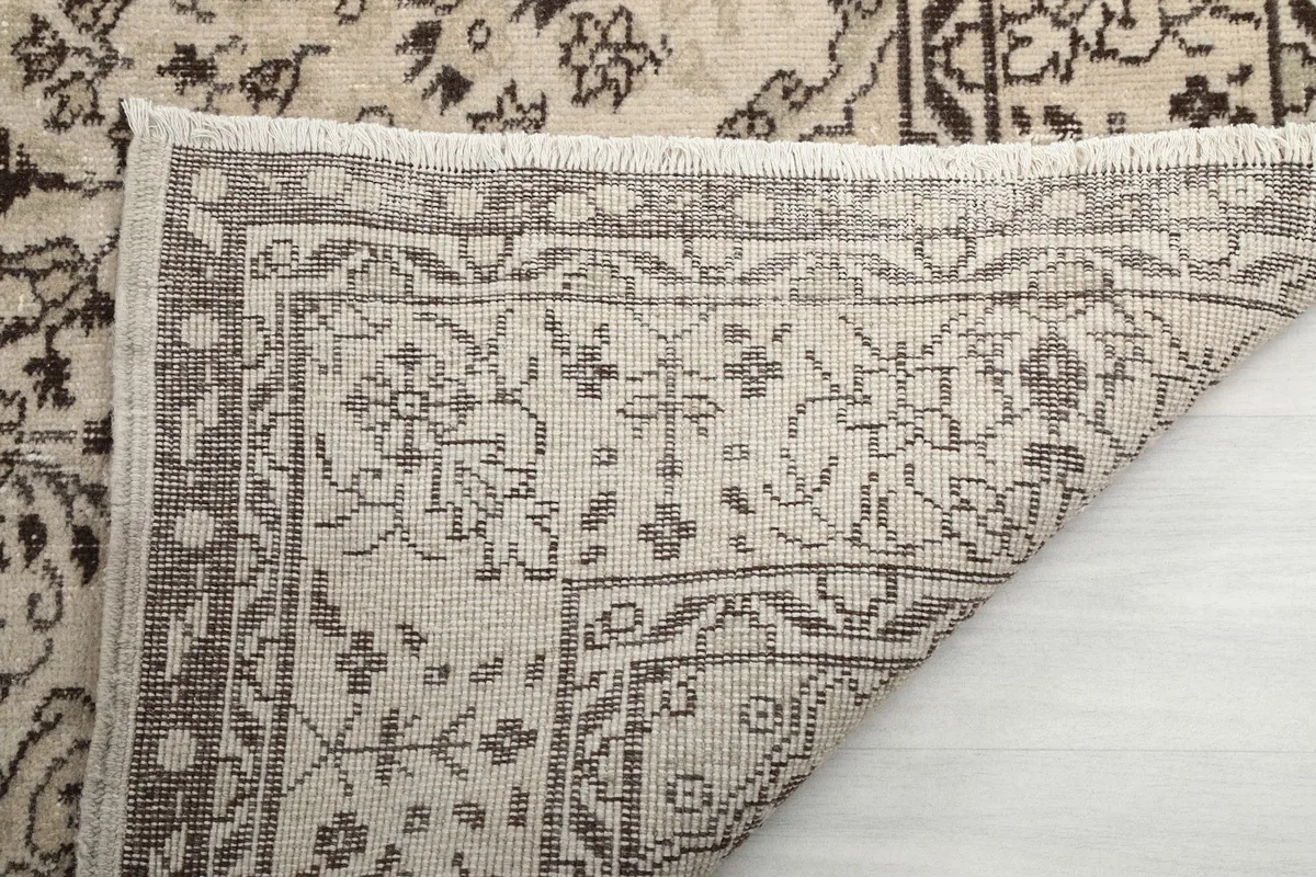 Close-up of the rug's back and fringe, illustrating the hand-knotted construction