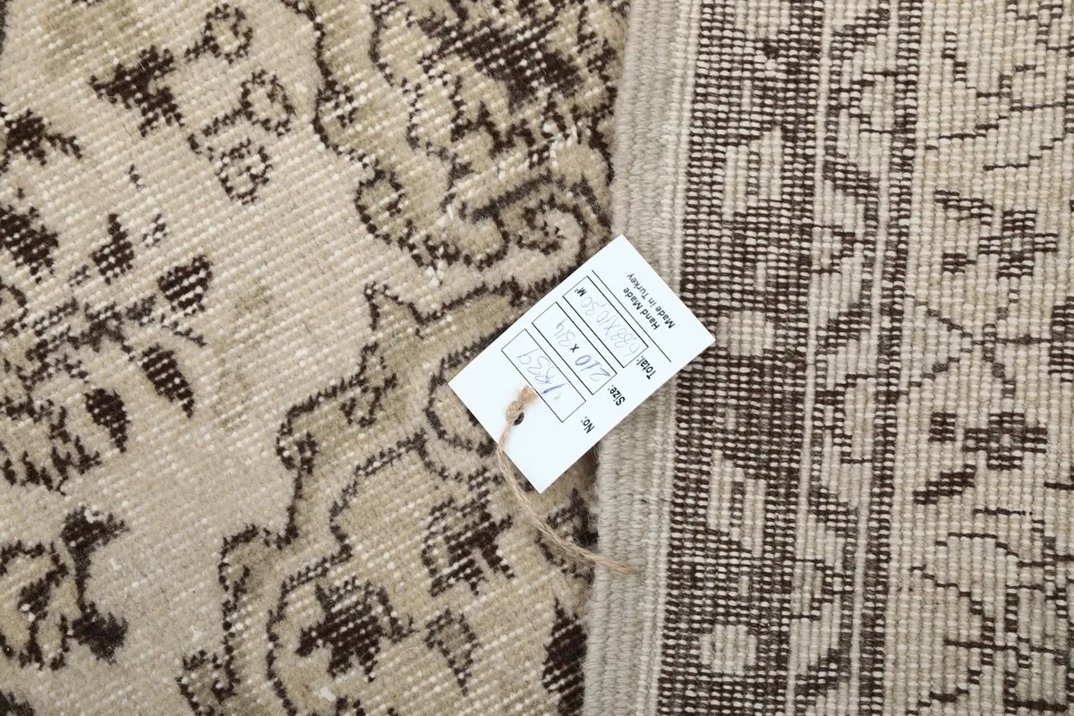 Detail of the rug's back with a product tag, showing construction and material