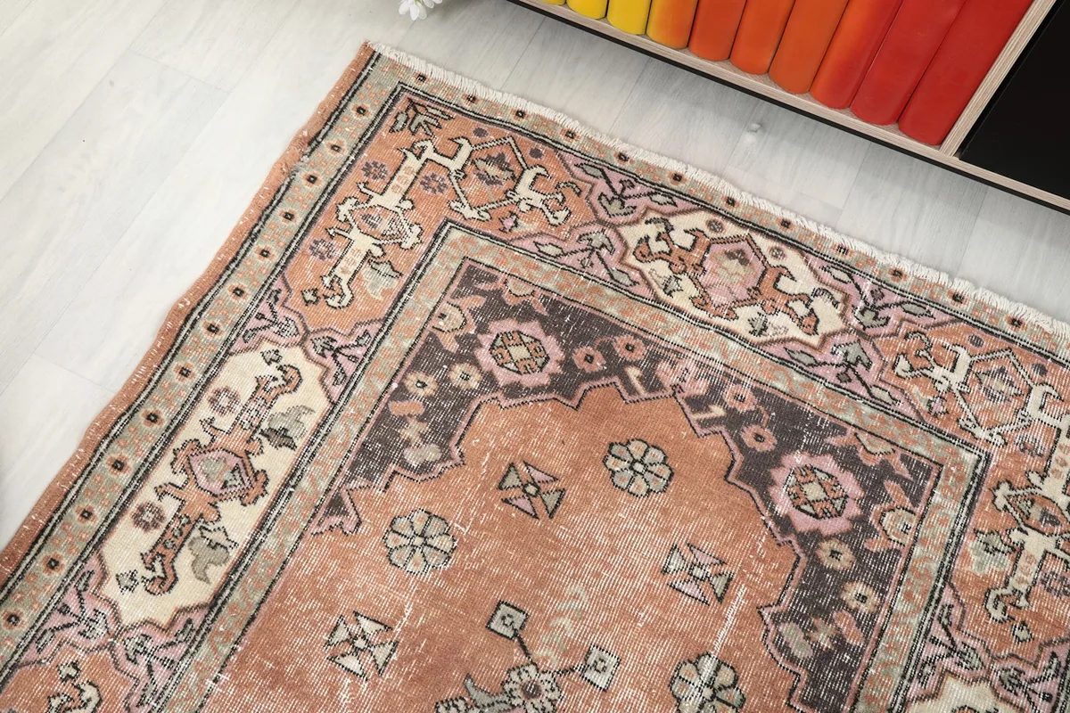 Upper right corner of the rug showing geometric patterns and color variations