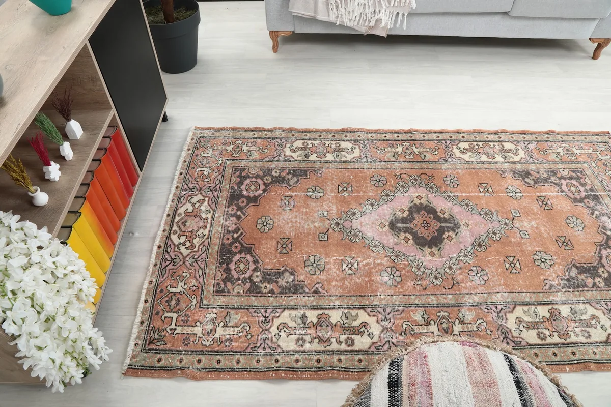 Wide angle view of the rug in a living room, showing its scale relative to furniture