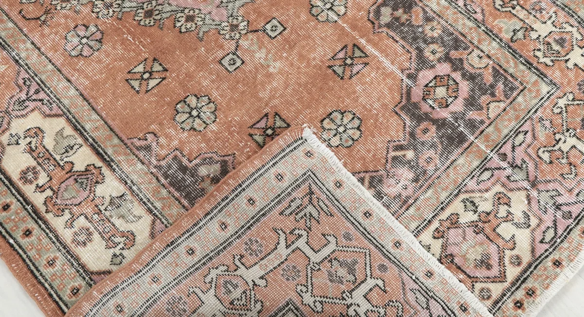 Rug folded to show the back and front texture, revealing construction
