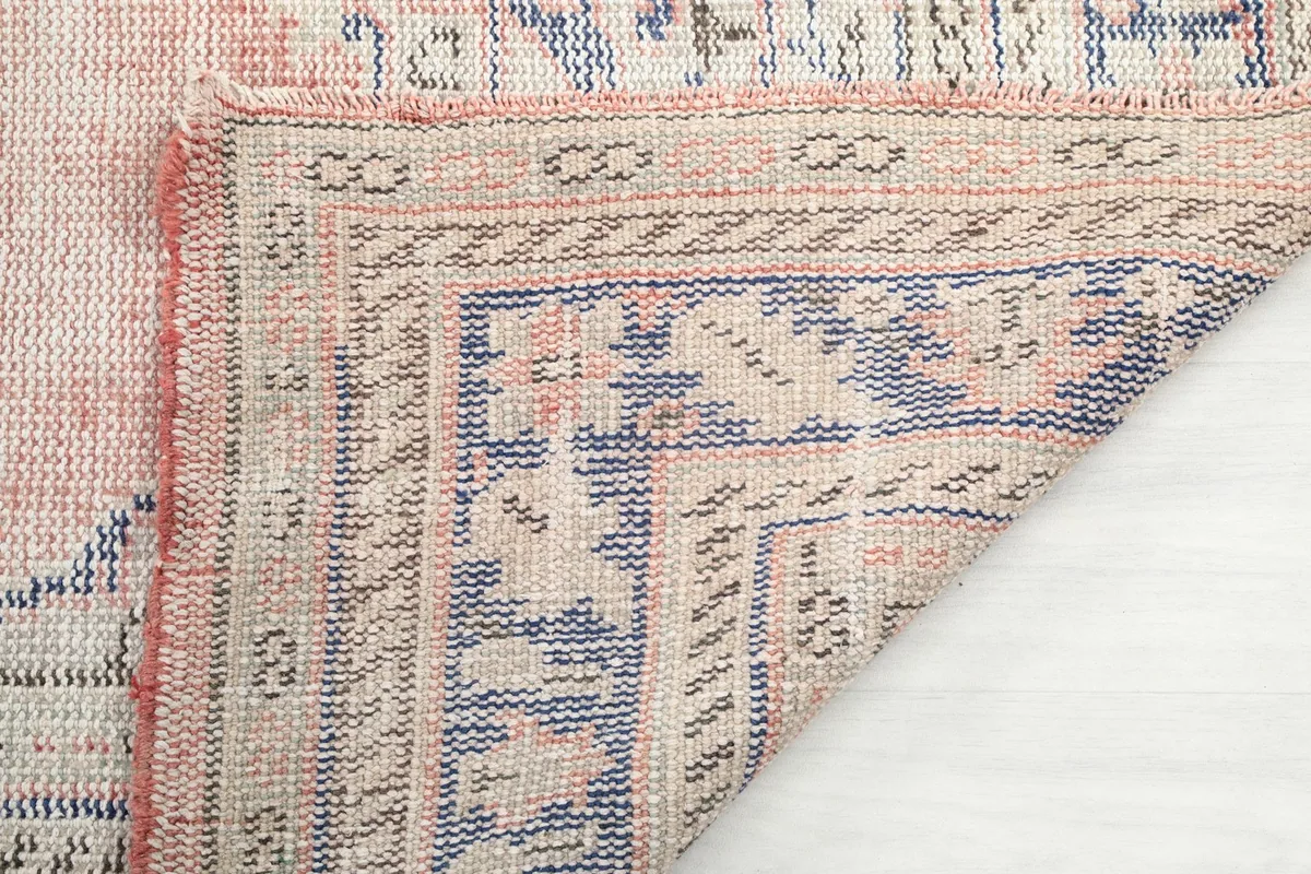 Close-up of the rug's cotton foundation and the back of the hand-knotted pile