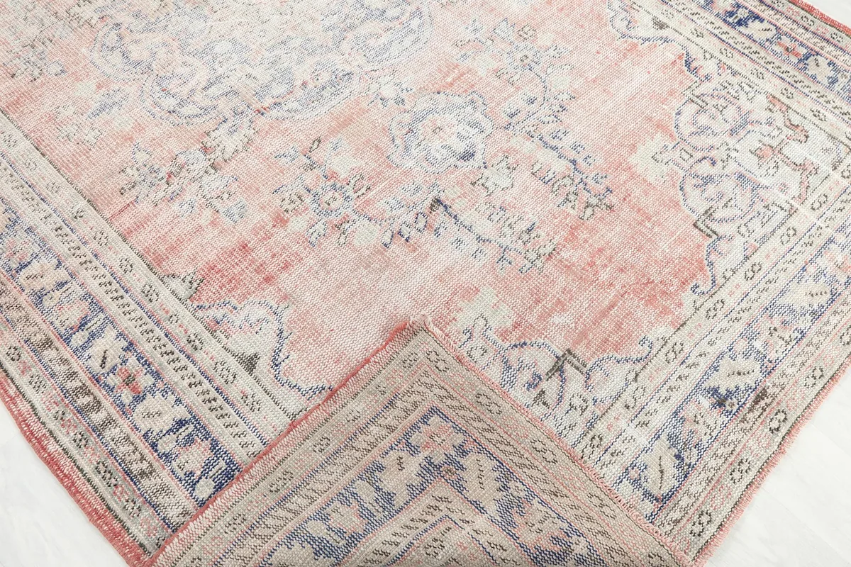Corner of the rug folded back to show the reverse side and knotting detail