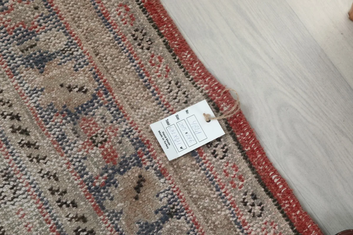 Small tag attached to the edge of the rug, showing part of the label