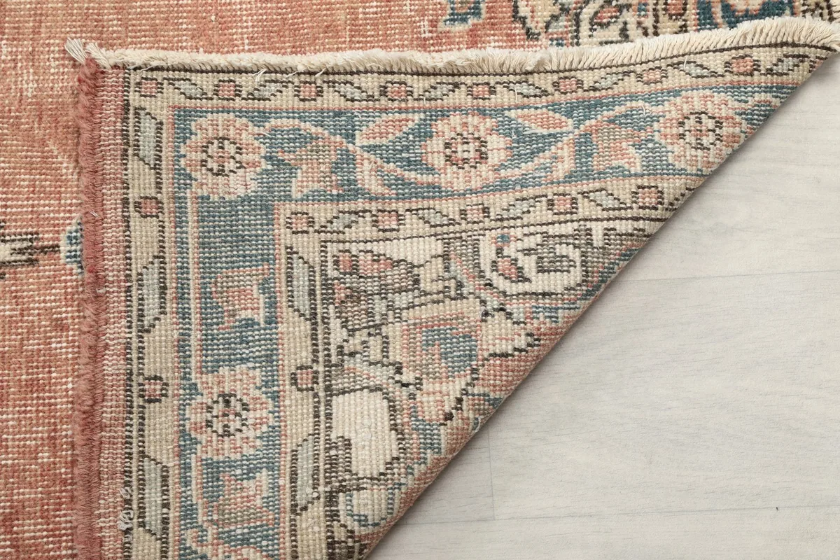 View of the back of the hand-knotted rug, revealing the cotton foundation and intricate knotting.