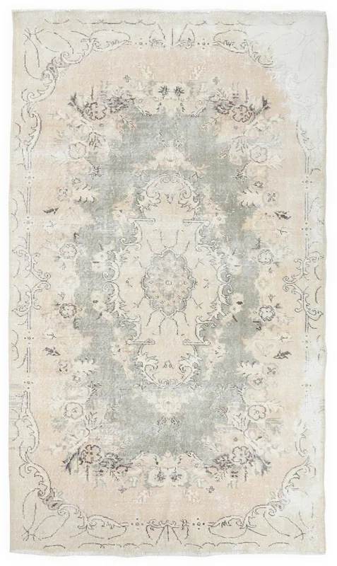 Full overhead view of the vintage Anatolian rug with a green medallion and beige field.