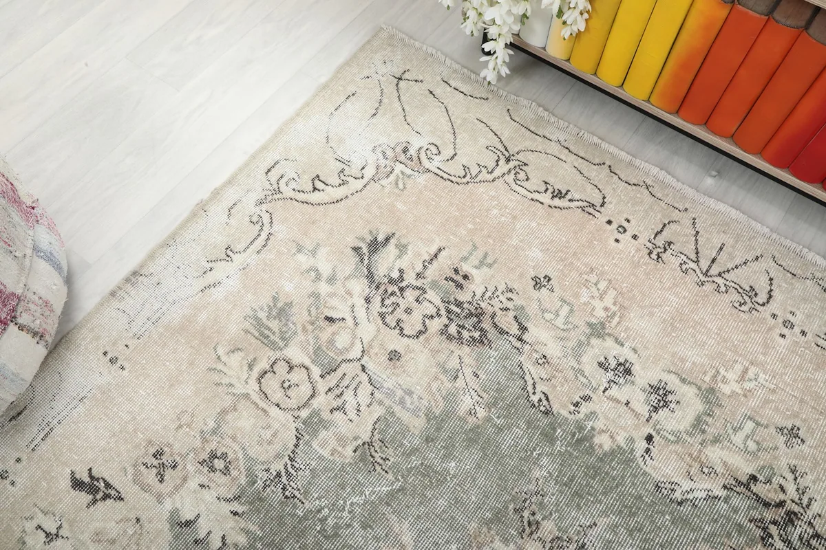 Angled view from above, showing the rug's upper section and its interaction with room elements.