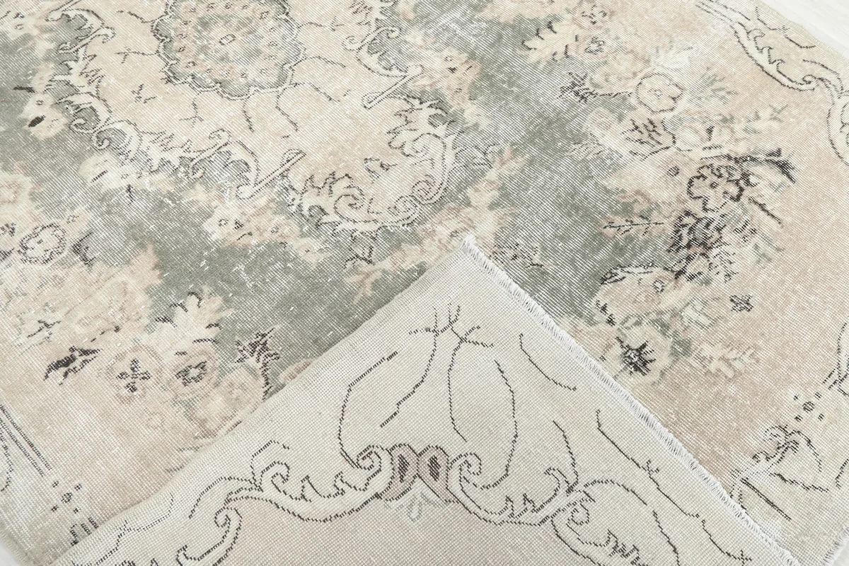 View of the rug's back, showing the hand-knotted cotton foundation and wool pile.