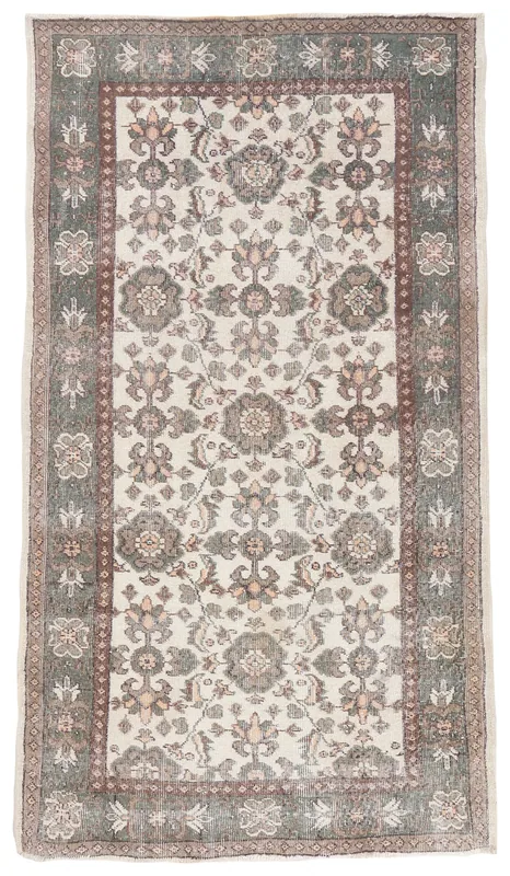Full top view of the vintage ivory Anatolian rug with floral and geometric motifs