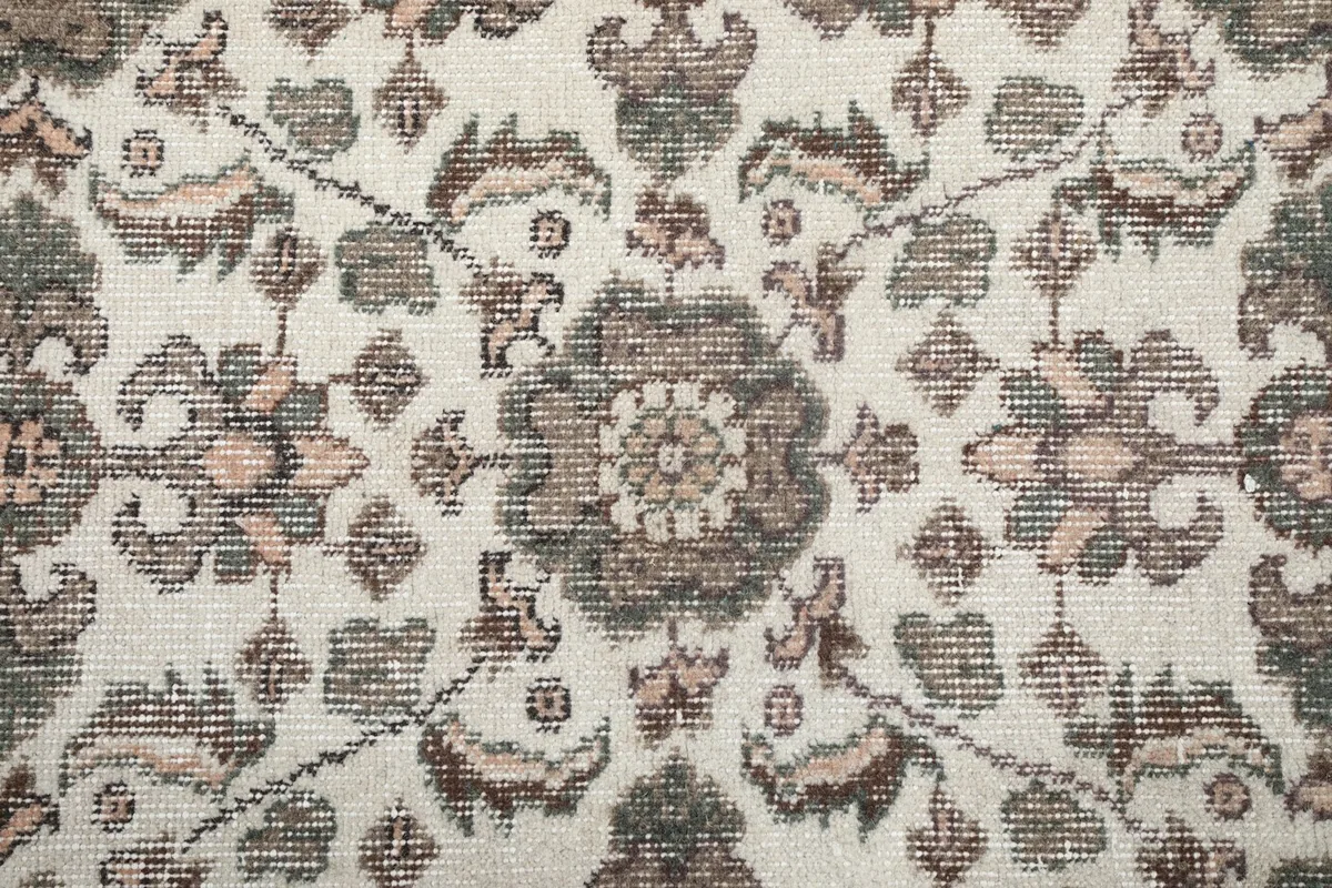 Close-up of a central floral medallion motif with surrounding geometric elements