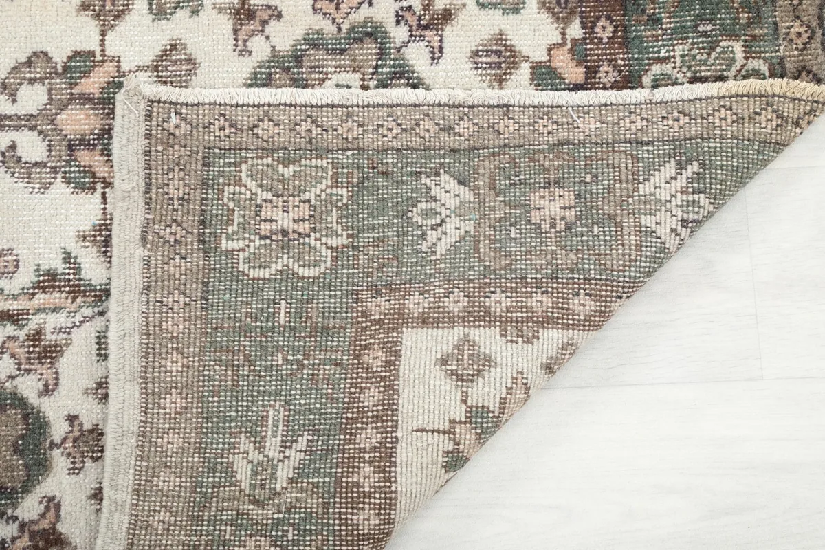 Detailed view of the rug's back, showing the tight hand-knotted wool on cotton foundation