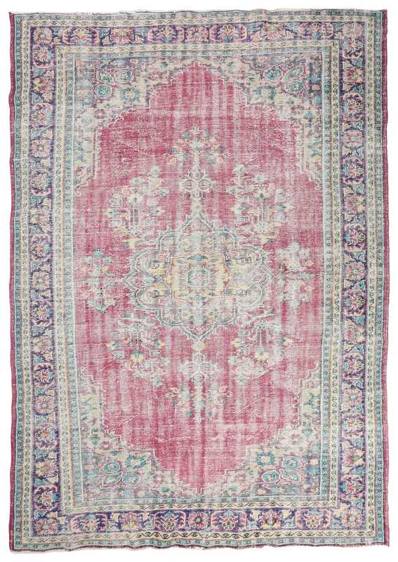 Full top view of the vintage rose and navy Anatolian area rug with a central medallion