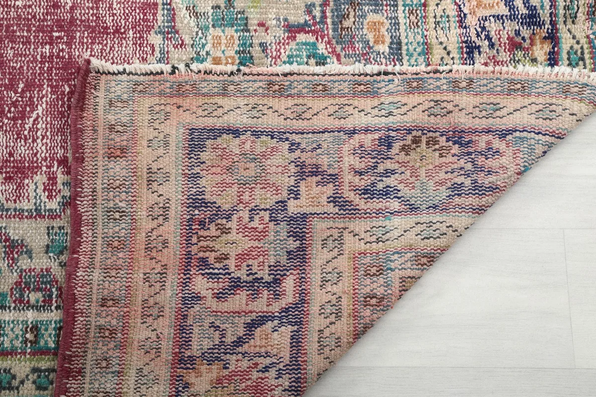 Underside view of the rug, showing the hand-knotted construction and cotton foundation