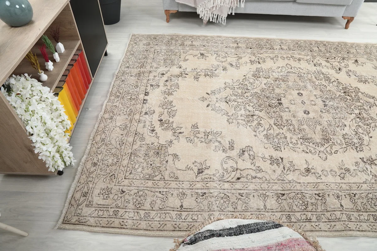 Wide shot of the ivory and gray rug in a room, capturing its placement relative to furniture.