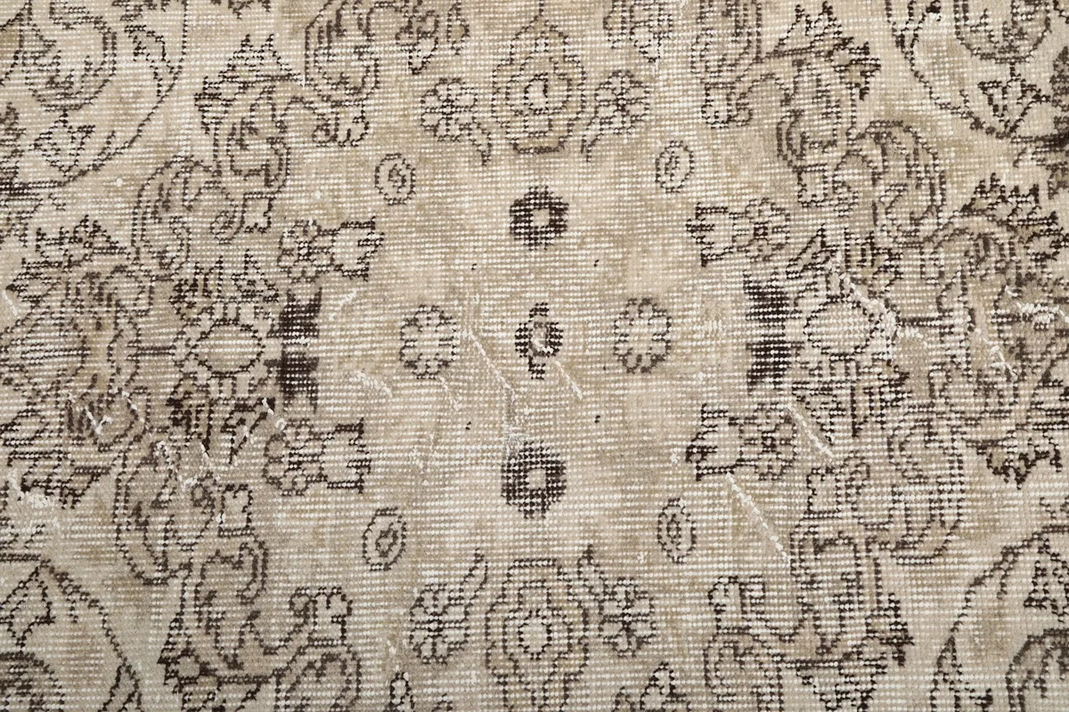 Texture detail of the low pile wool surface, showing the subtle color variations and hand-knotted quality.