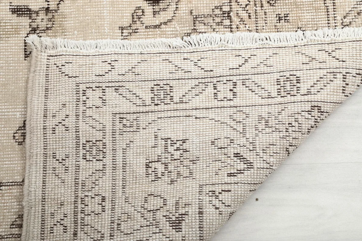Close-up of the back of the hand-knotted rug, showing the cotton foundation and knotting detail.