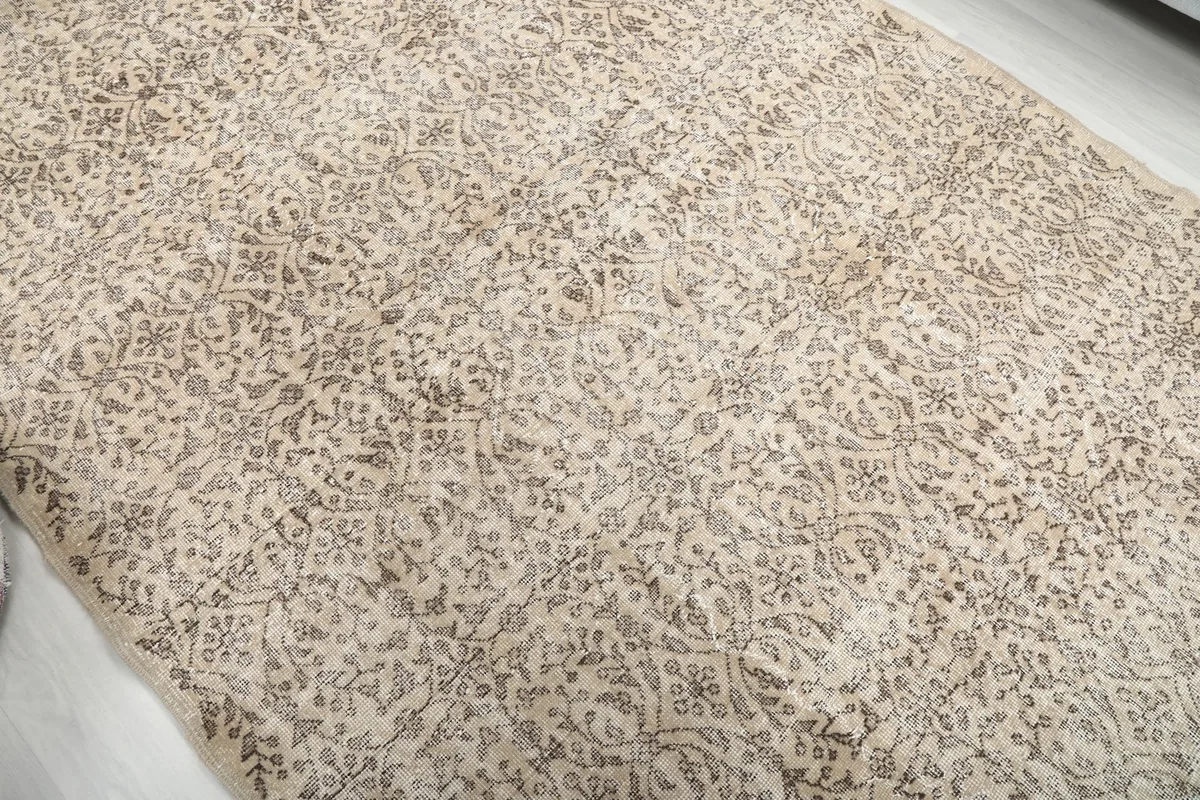 Overhead view highlighting the distressed texture and intricate pattern of the hand-knotted wool rug.