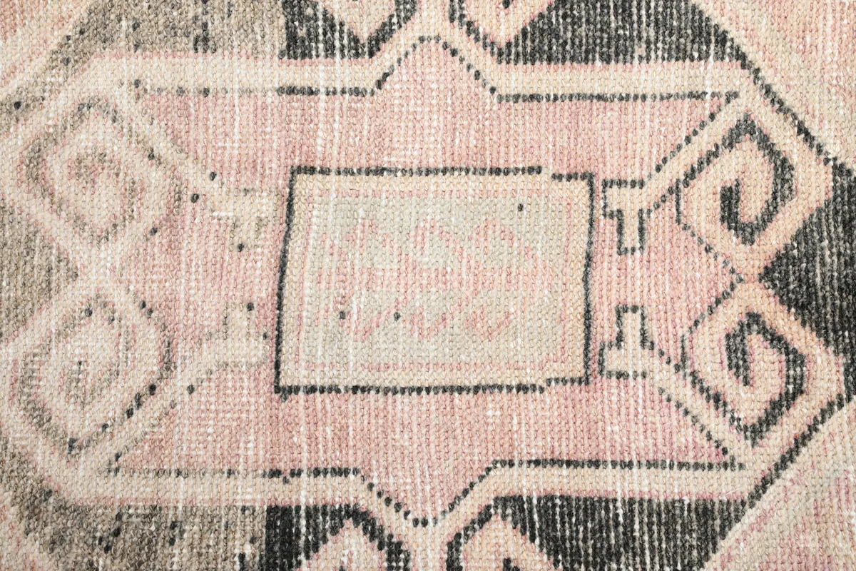 Detailed view of the hand-knotted pile and central motif