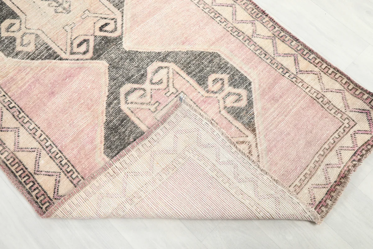 Corner of the Faded Rose Diamond Tribal Runner folded to show thickness and back