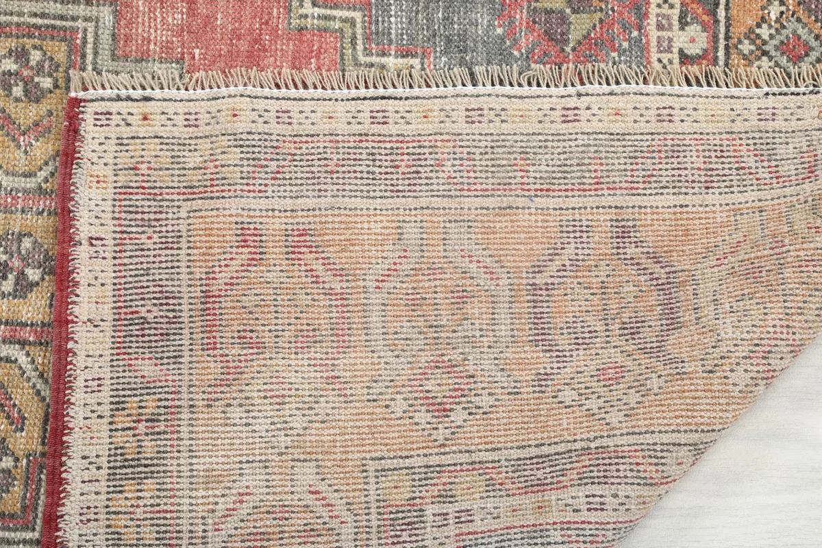 Close-up of the rug's back, revealing the knotting and fringe