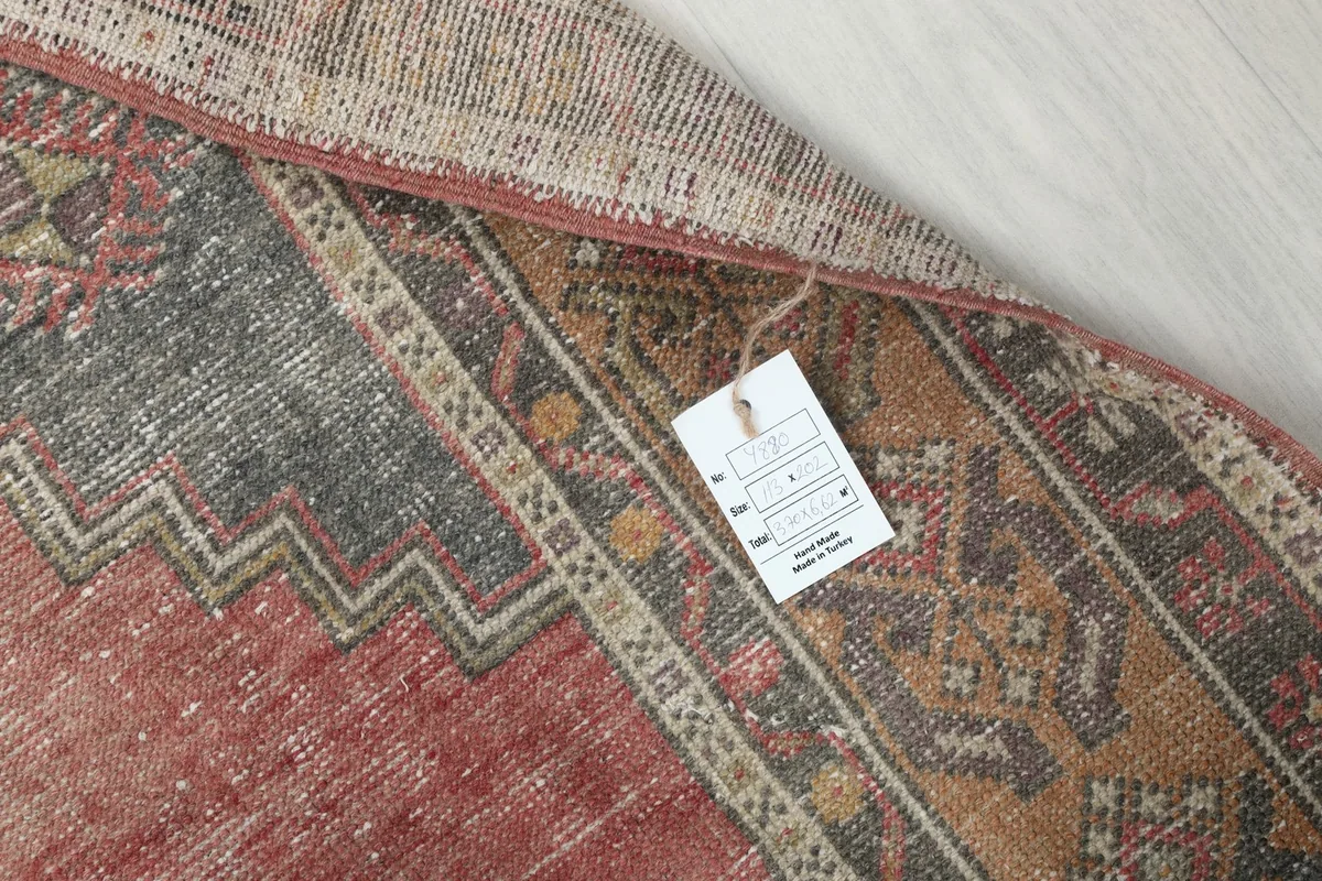 Corner of the rug with a product tag, showing the material and origin details