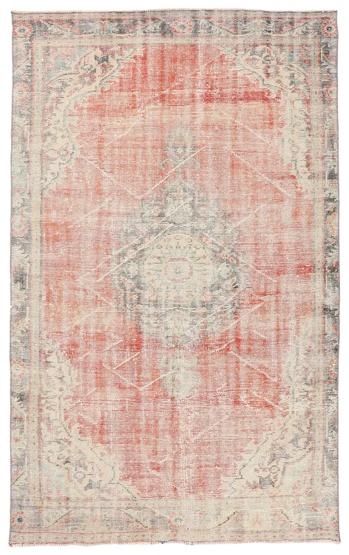 Full overhead view of a vintage rust and beige medallion area rug on a white background.
