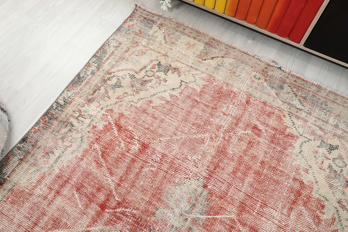 Upper corner of the rug, showcasing the aged texture and color variations.