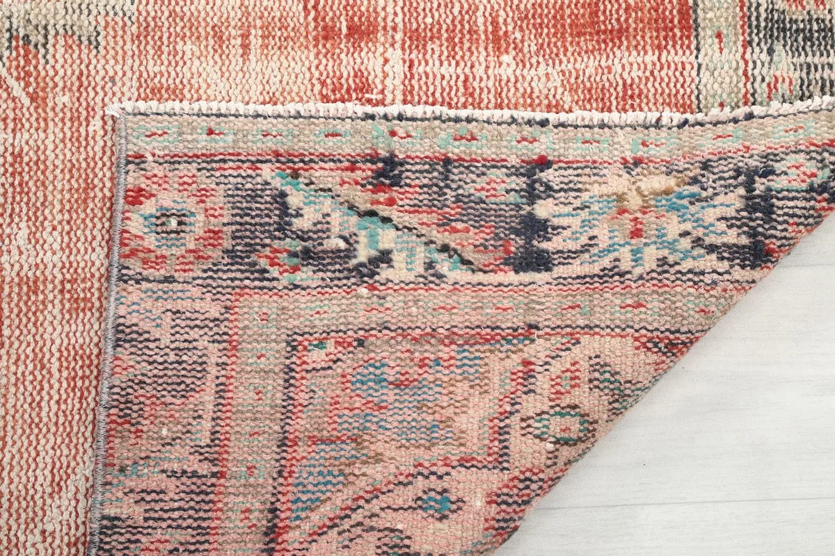 View of the rug's reverse side, showing the hand-knotted cotton foundation.