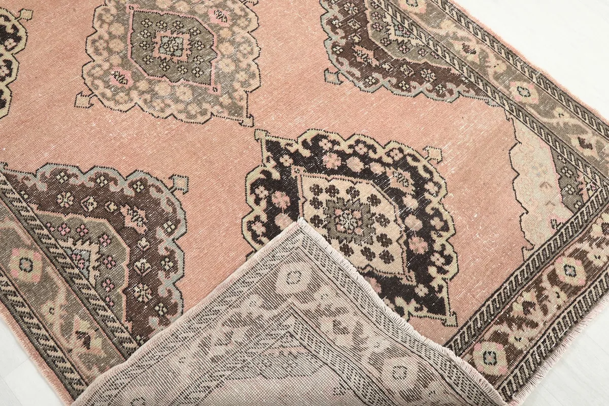 Folded corner of the rug revealing the cotton foundation and hand-knotted construction