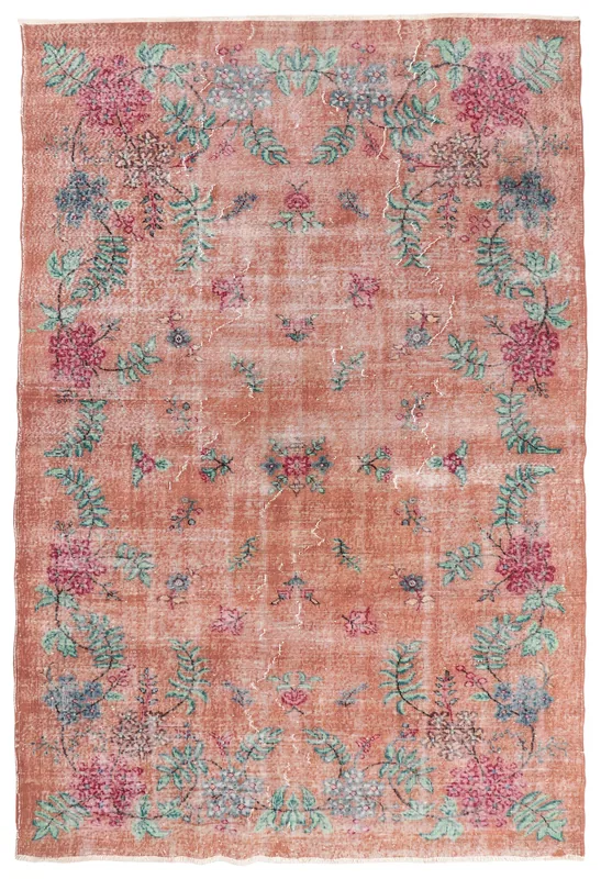 Full overhead view of the rust floral vintage Anatolian rug on a white background