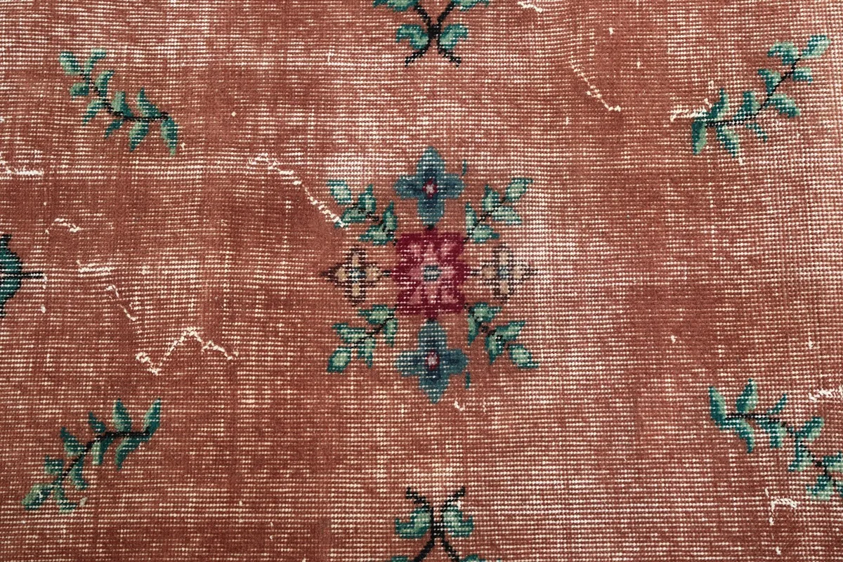 Detailed view of a central floral medallion and the texture of the low pile