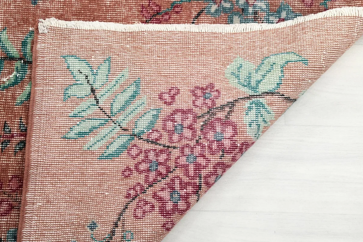 Close-up of the rug's reverse side, showing the intricate hand-knotting and fringe detail