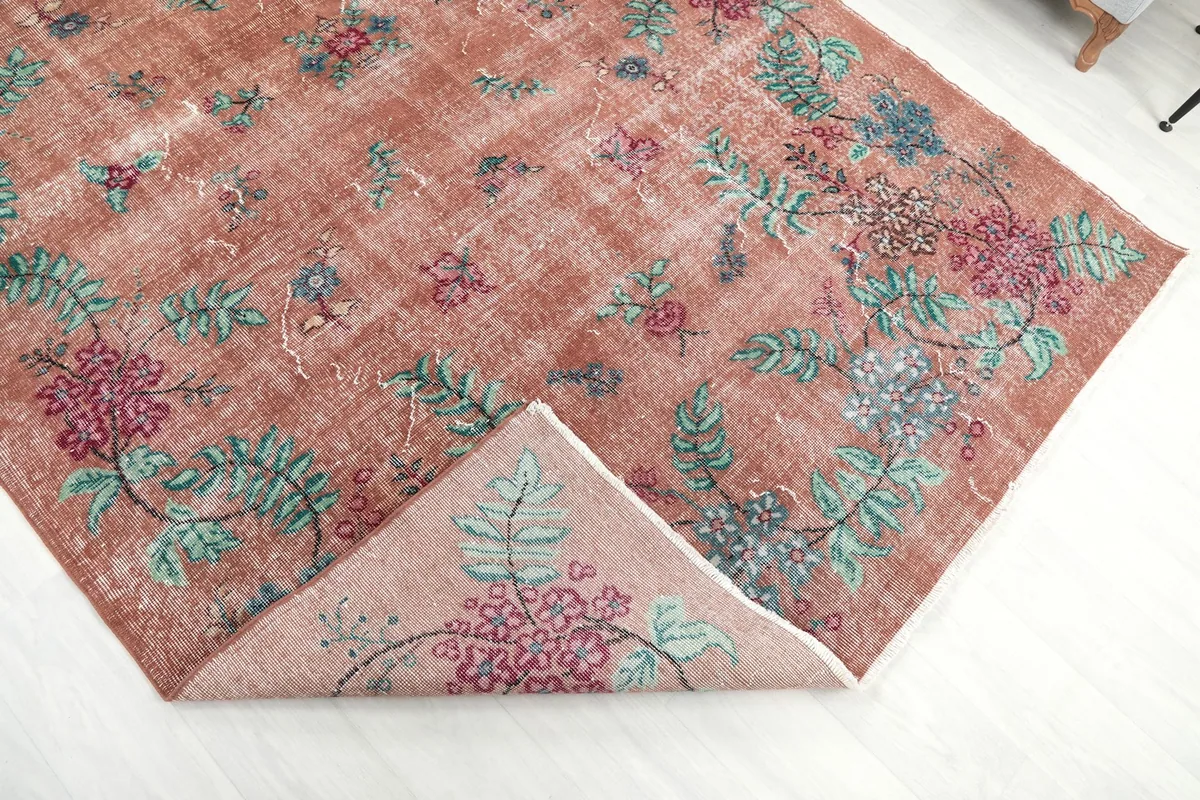 Folded corner of the rug, revealing the back of the hand-knotted wool on cotton foundation