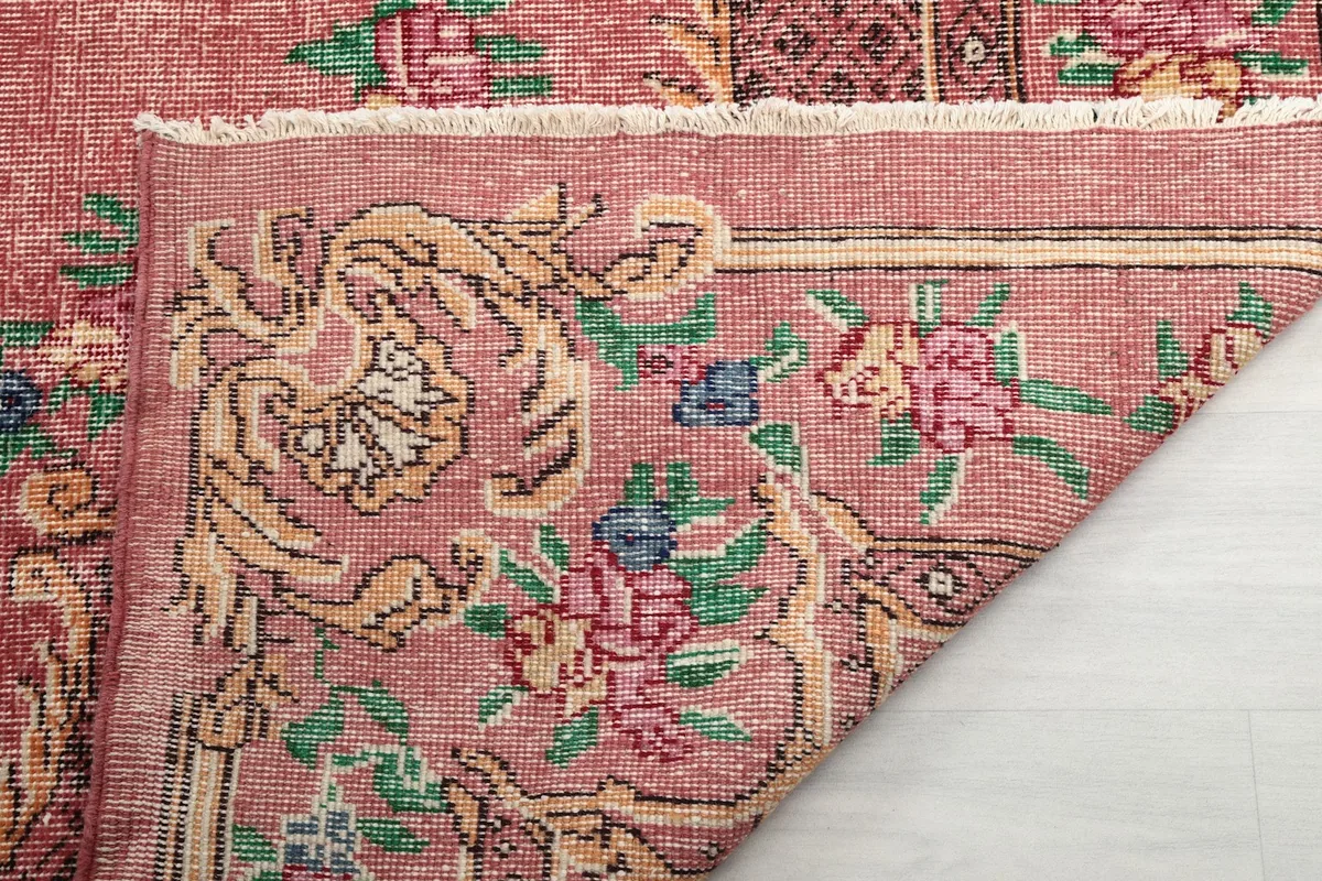 Close-up of the rug's back, revealing the hand-knotted construction and fringe