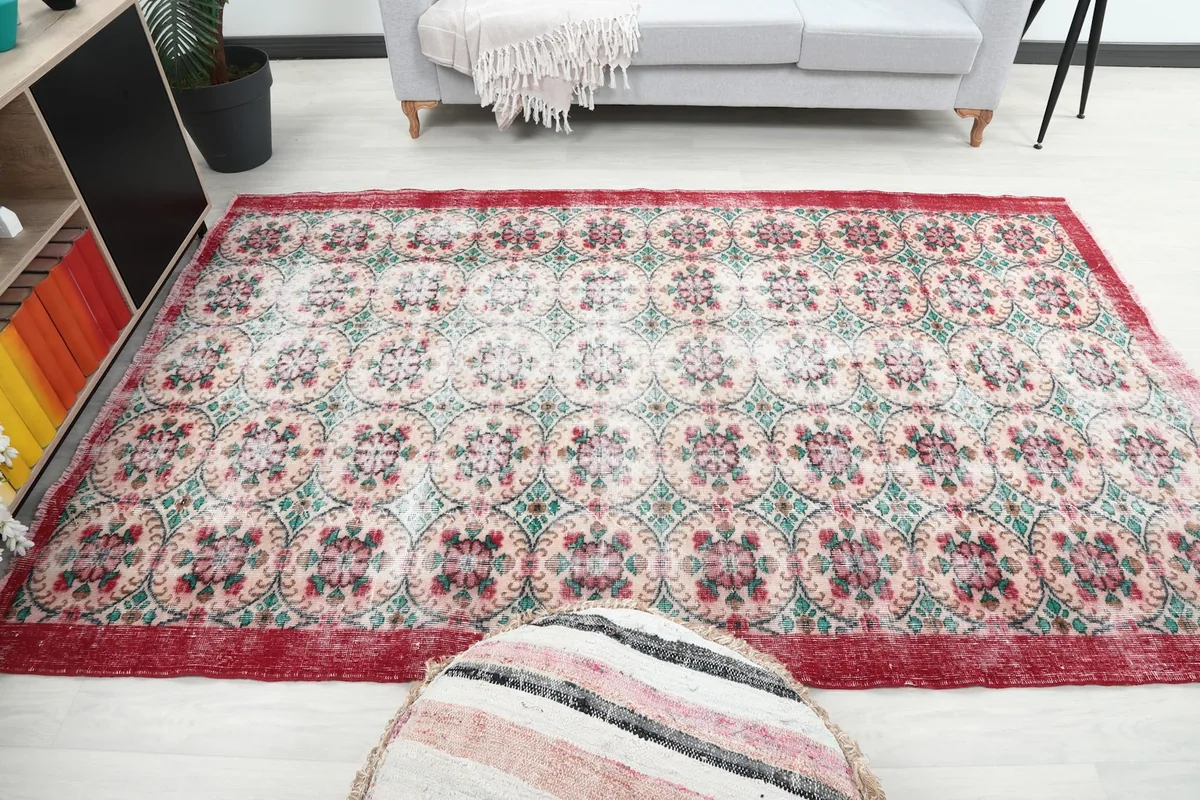 Wide shot of the red and cream rug in a room, demonstrating its medium size and design