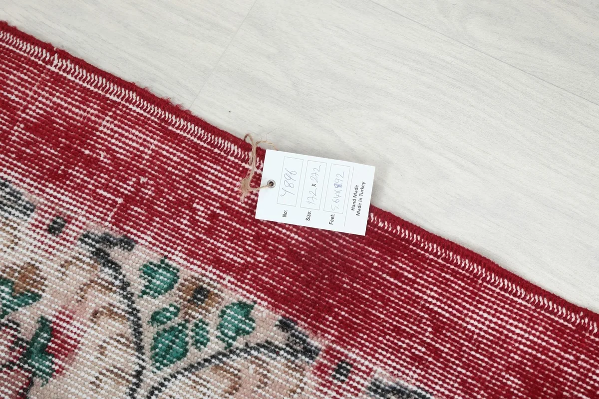 Close-up of the rug's corner with a product tag, indicating its origin and materials