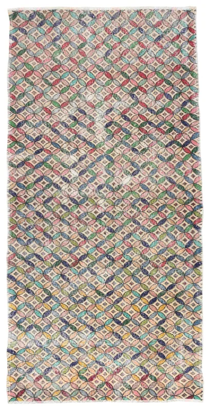 Full overhead view of the multicolor geometric vintage Anatolian runner rug on a white background