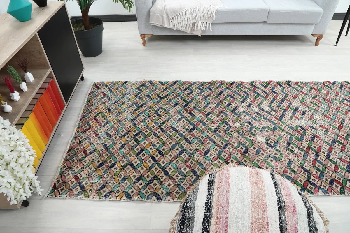 Wide angle view of the multicolor geometric runner rug placed in a room with light flooring