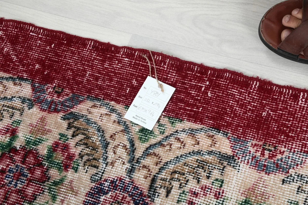 Detail of the rug's edge and foundation, with a product tag visible