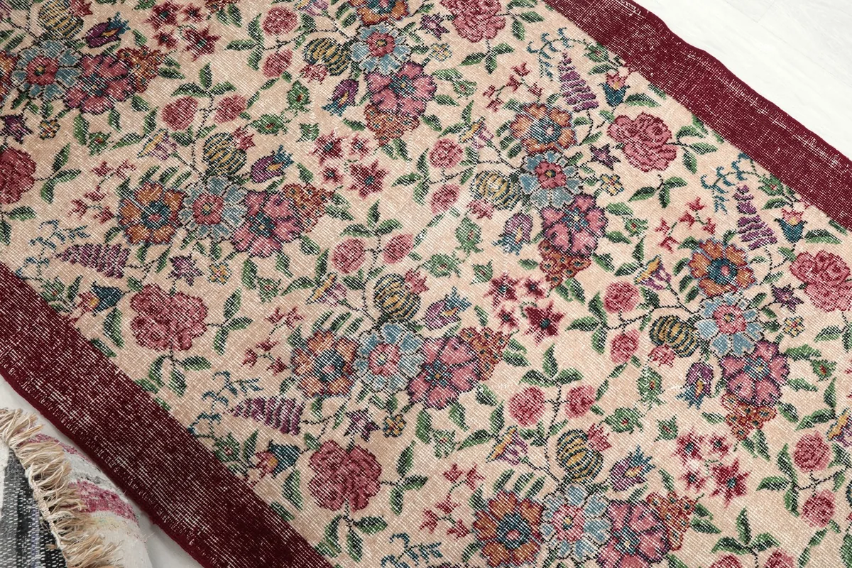 Overhead angle view capturing the full floral design and color variations across the rug.