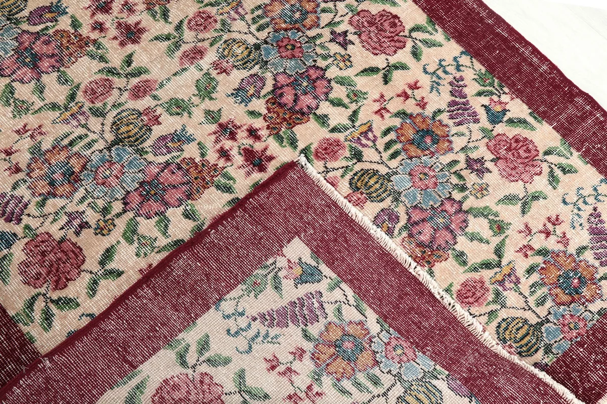 View of the rug folded back to show the reverse side and the quality of the hand-knotting.