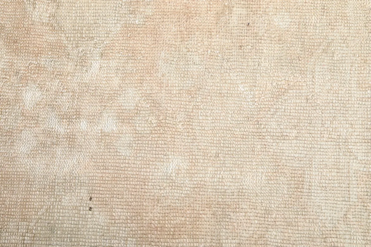 Close-up of the rug's low wool pile, showing its texture and hand-knotted construction